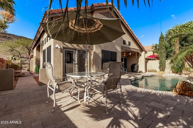 view of patio / terrace with a gate, fence, and outdoor dining area