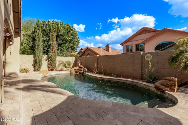 view of pool with a fenced backyard and a patio