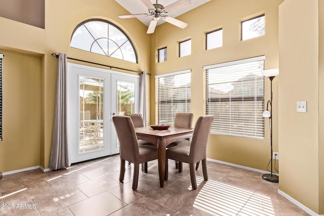 dining room with a high ceiling, french doors, baseboards, and ceiling fan