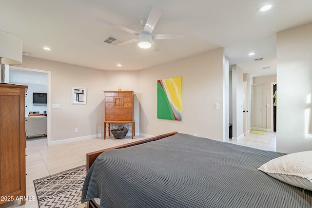 bedroom with ensuite bath, ceiling fan, and light tile patterned flooring