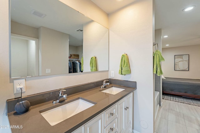 bathroom with vanity and a tub