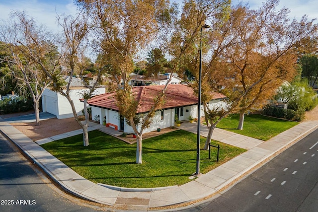 view of front of property with a front yard and a garage