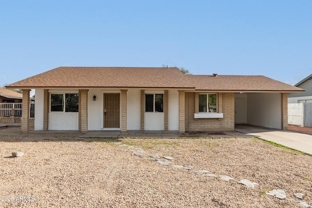 single story home with fence, brick siding, concrete driveway, and a shingled roof