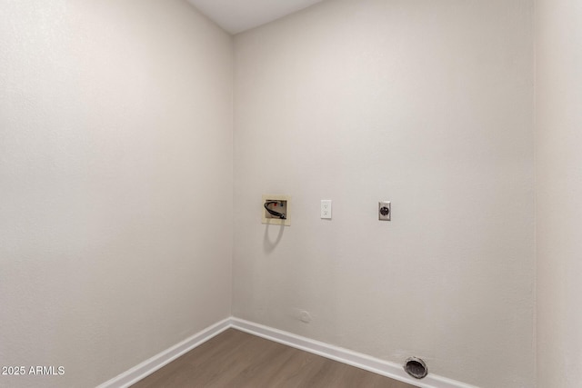 washroom with electric dryer hookup, dark wood finished floors, baseboards, hookup for a washing machine, and laundry area