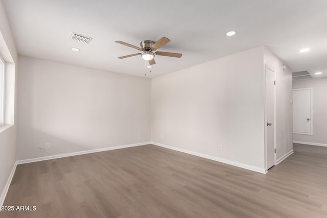 spare room with a ceiling fan, wood finished floors, visible vents, baseboards, and recessed lighting