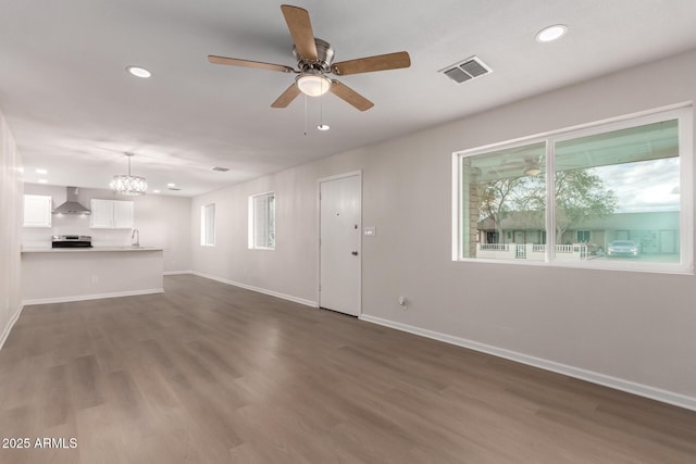 unfurnished living room featuring visible vents, recessed lighting, baseboards, and dark wood-style flooring