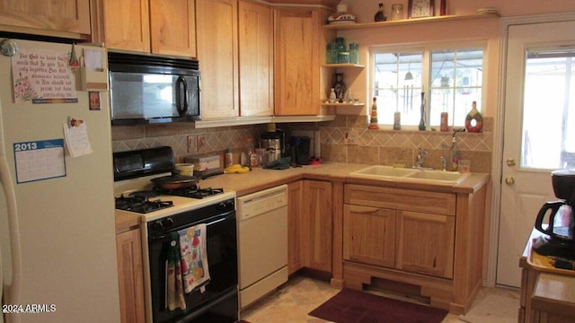 kitchen with decorative backsplash, sink, and white appliances