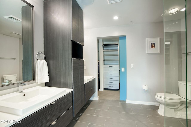 bathroom featuring toilet, tile patterned floors, and vanity