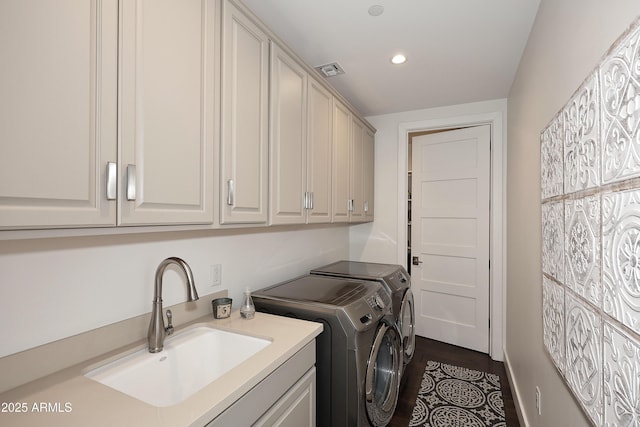 laundry room featuring visible vents, recessed lighting, cabinet space, a sink, and washer and clothes dryer