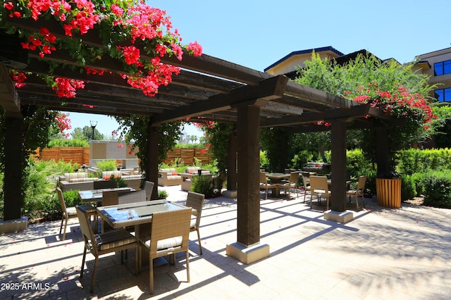 view of patio / terrace featuring a pergola, outdoor dining area, and fence