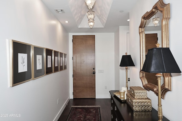 foyer with recessed lighting, visible vents, baseboards, and dark wood-style floors