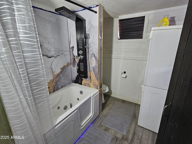 bathroom featuring shower / bathtub combination with curtain, hardwood / wood-style flooring, a textured ceiling, and toilet