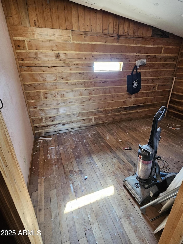 details with hardwood / wood-style flooring and wood walls