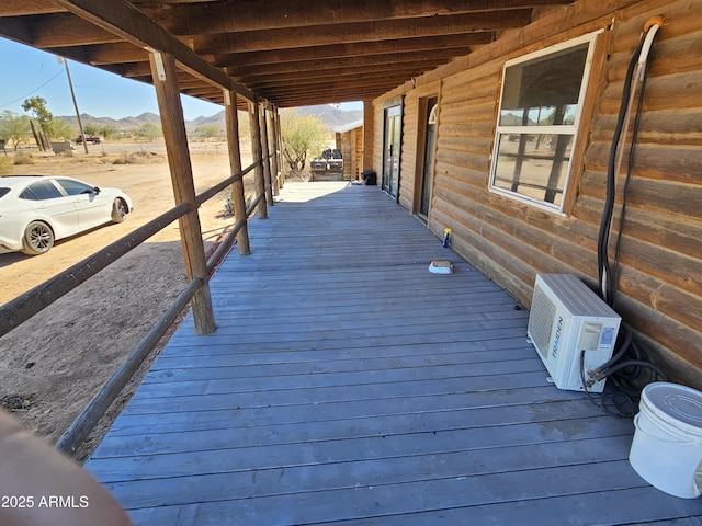 wooden terrace featuring a mountain view and ac unit