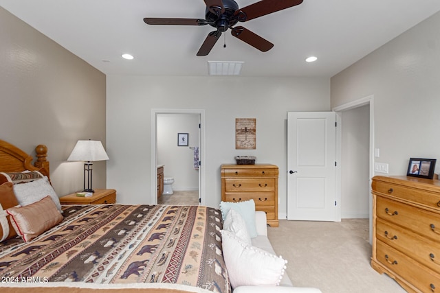 bedroom featuring ensuite bath, ceiling fan, and light carpet