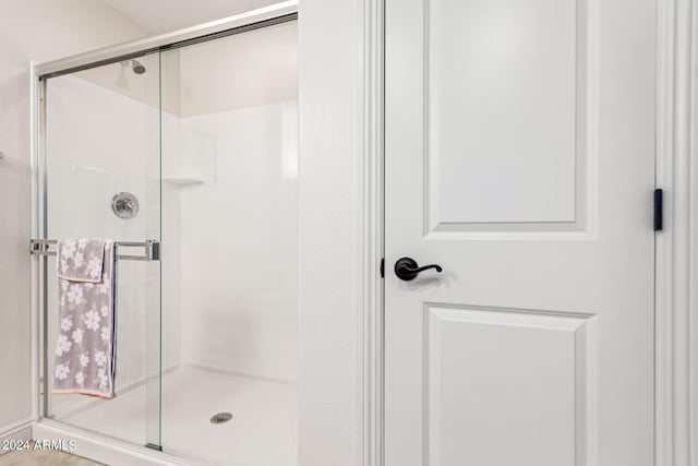 bathroom with a shower with shower door