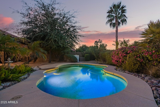 view of pool at dusk