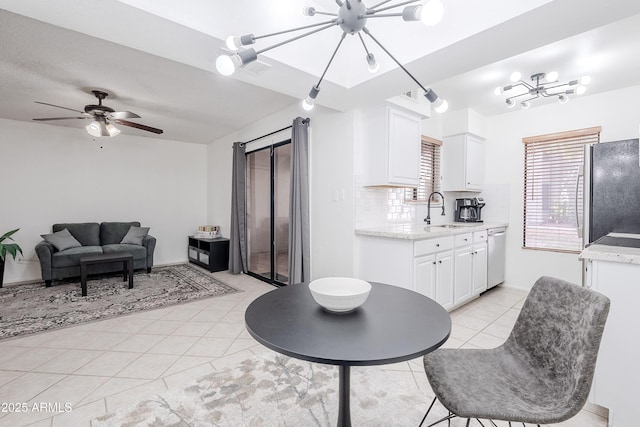 interior space with sink, light tile patterned floors, and ceiling fan with notable chandelier