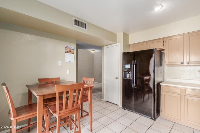 dining area featuring light tile patterned flooring and visible vents
