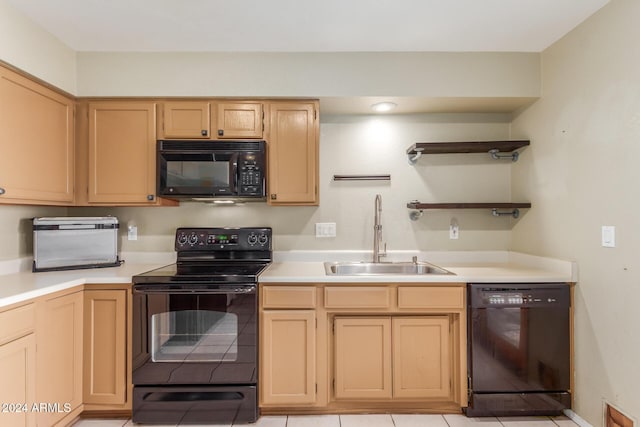 kitchen with light brown cabinets, light countertops, a sink, light tile patterned floors, and black appliances