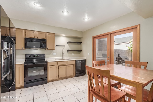 kitchen with french doors, light tile patterned floors, black appliances, and sink