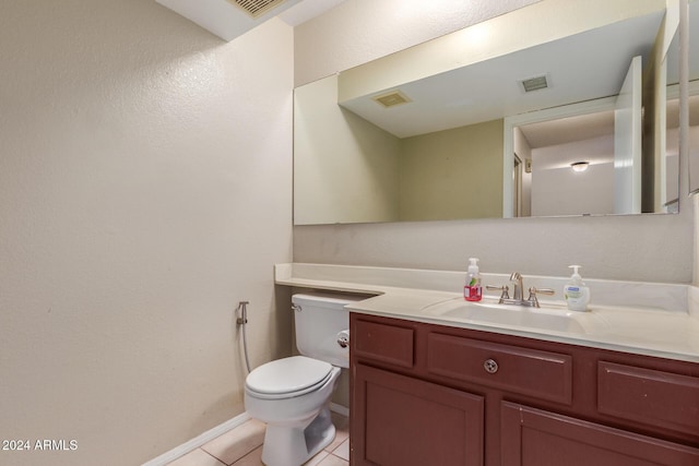 bathroom featuring vanity, toilet, tile patterned floors, baseboards, and visible vents