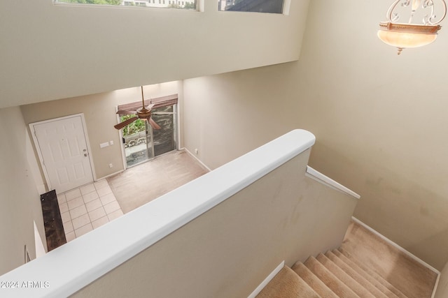 stairs featuring baseboards and tile patterned flooring