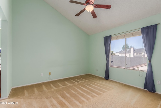 carpeted empty room with ceiling fan, a textured ceiling, and lofted ceiling