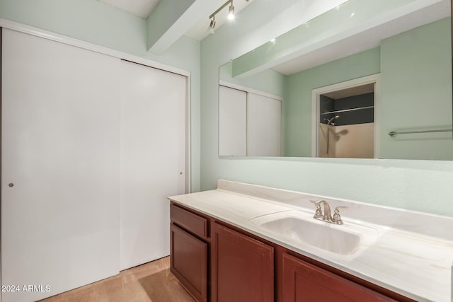 full bath with vanity and a shower