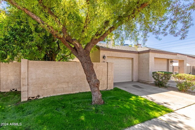 view of front of home with a front lawn and a garage