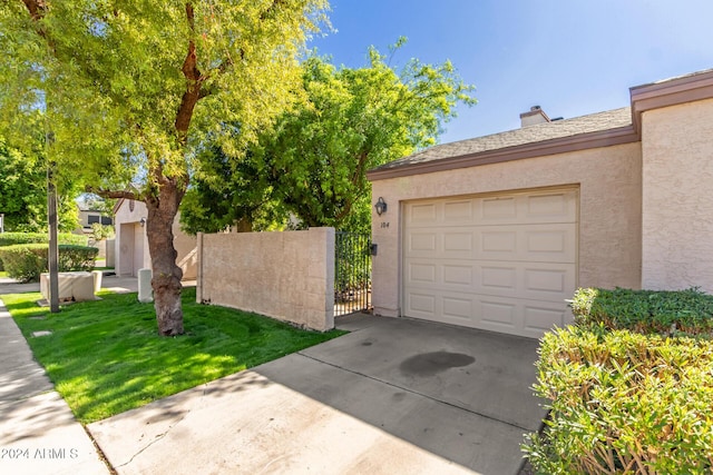 exterior space featuring a gate, fence, and concrete driveway