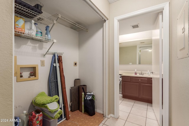 laundry area with washer hookup, hookup for an electric dryer, visible vents, a sink, and light tile patterned flooring