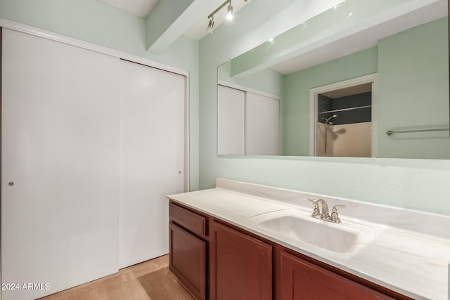 bathroom with vanity and walk in shower