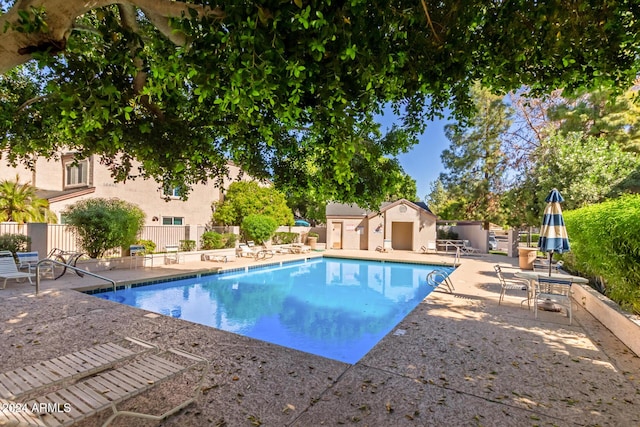 pool featuring a patio and fence