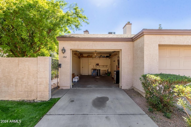 exterior space featuring concrete driveway, a gate, and a garage
