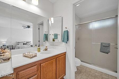 full bathroom featuring a shower stall, vanity, a ceiling fan, and toilet
