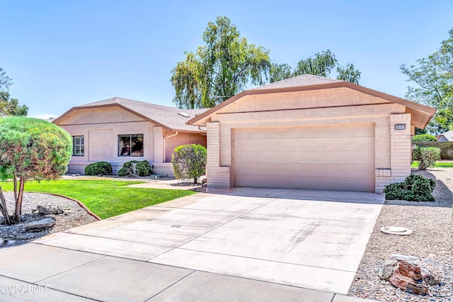 ranch-style house featuring stucco siding, roof with shingles, a front yard, an attached garage, and concrete driveway