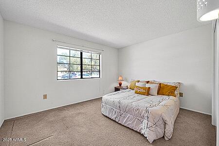 bedroom featuring carpet and a textured ceiling