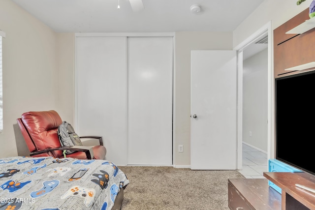 carpeted bedroom featuring a closet and ceiling fan