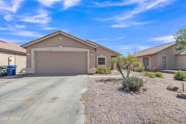 ranch-style house featuring driveway, stucco siding, an attached garage, and a tile roof