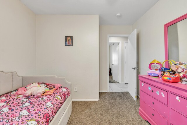 bedroom with baseboards and light colored carpet