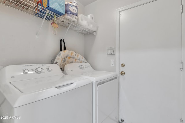 clothes washing area featuring washer and dryer and laundry area