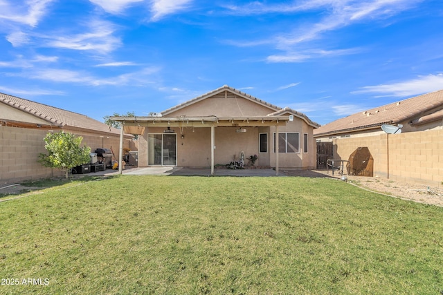 rear view of property with a patio area, a fenced backyard, a yard, and stucco siding