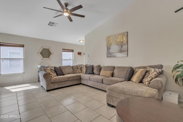 living room with visible vents, ceiling fan, high vaulted ceiling, and light tile patterned flooring