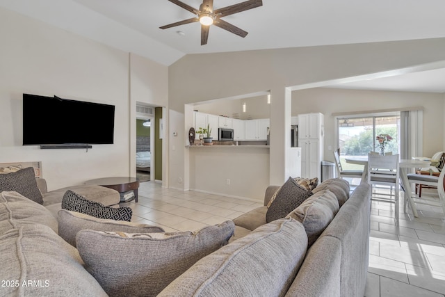 living room with high vaulted ceiling, light tile patterned floors, and a ceiling fan