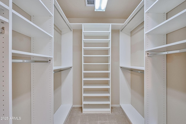 spacious closet featuring visible vents and carpet