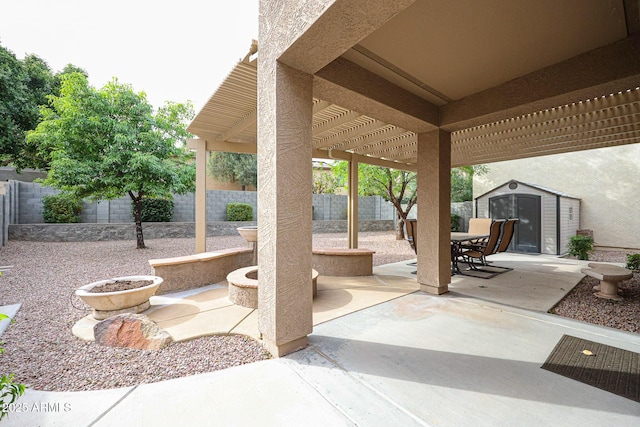 view of patio / terrace with a shed, outdoor dining area, a fenced backyard, a pergola, and an outdoor structure