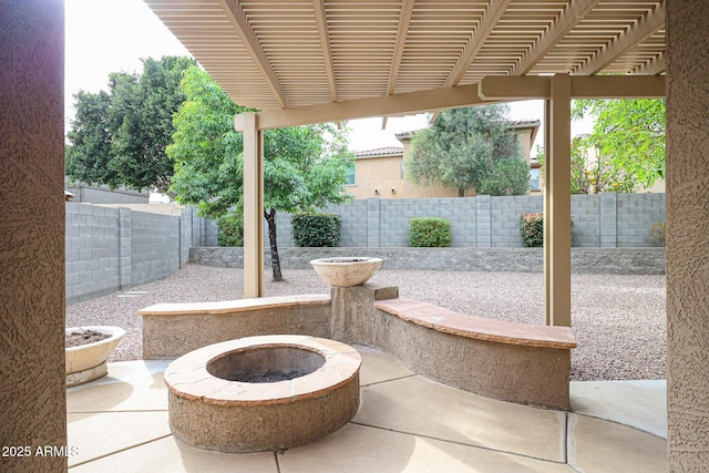 view of patio with a fire pit, a fenced backyard, and a pergola