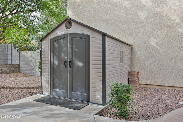 view of shed with fence