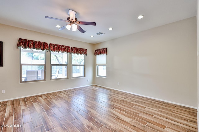 empty room with visible vents, light wood-style flooring, a ceiling fan, recessed lighting, and baseboards